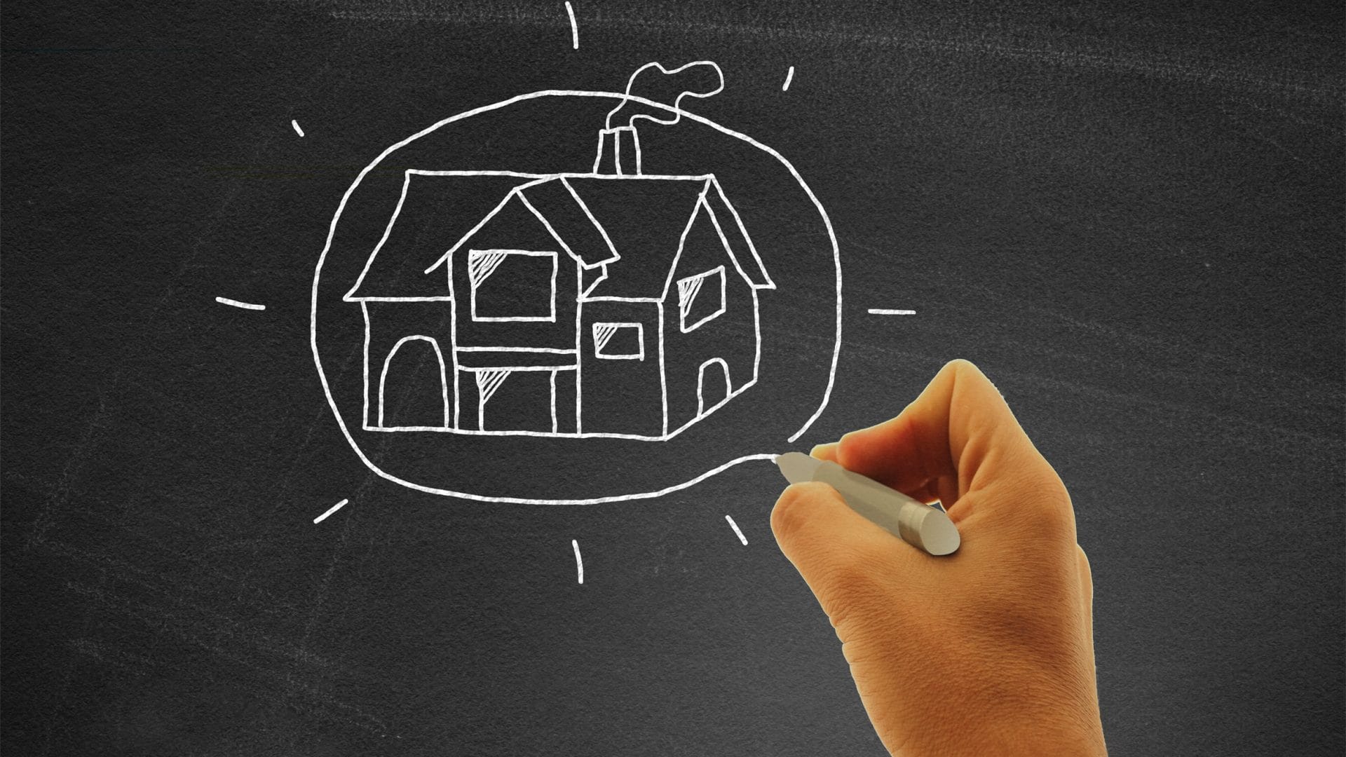 stockvault-hand-drawing-a-house-on-blackboard-real-estate-and-housing-concept178132